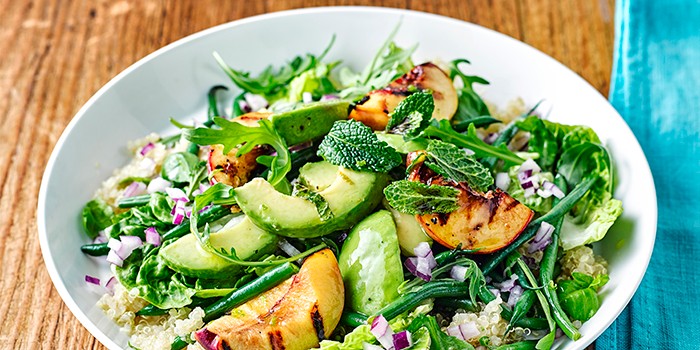 Mint and basil griddled peach salad in a bowl