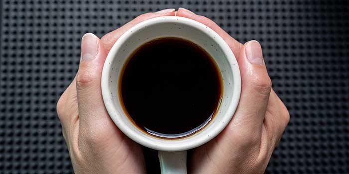 Someone holding a cup of coffee
