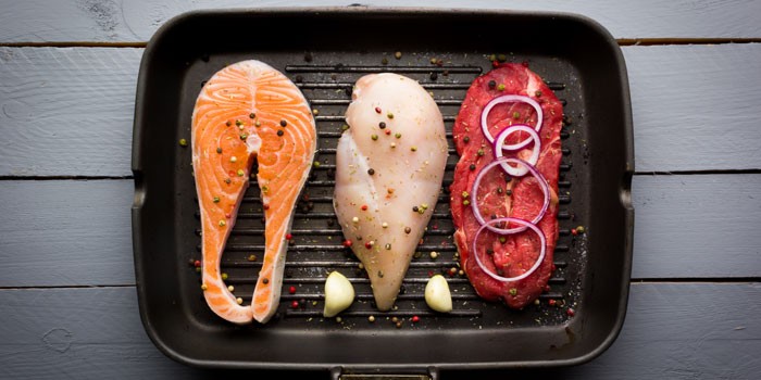 Salmon, beef and chicken in a griddle pan