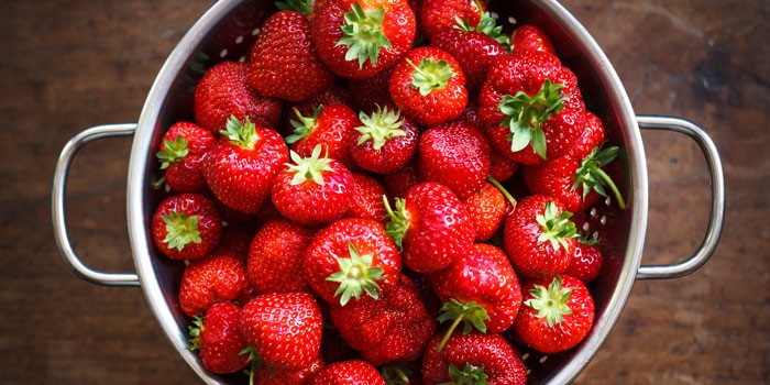 Fresh strawberries in a colander