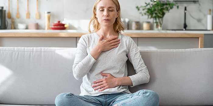 A woman doing calming breathing exercises