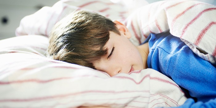 Child sleeping in a light room