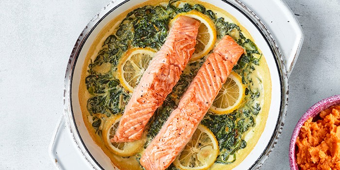 Creamy garlic and lemon spinach salmon in a casserole dish