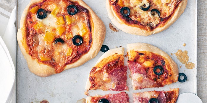 Three mini pizzas, homemade by kids