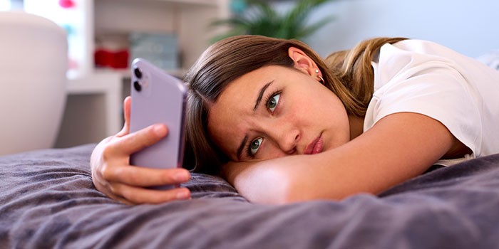 Woman looking stressed looking at her phone