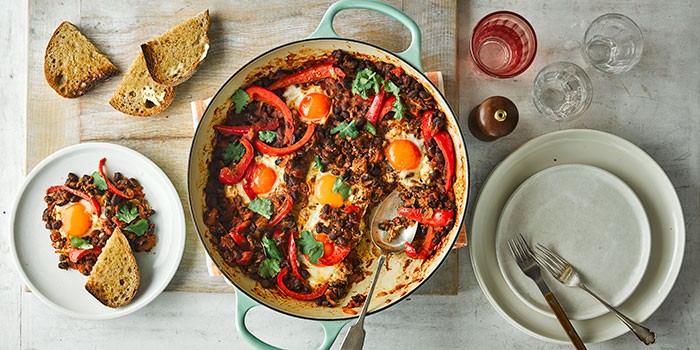 Pan of eggs and beans with peppers and coriander