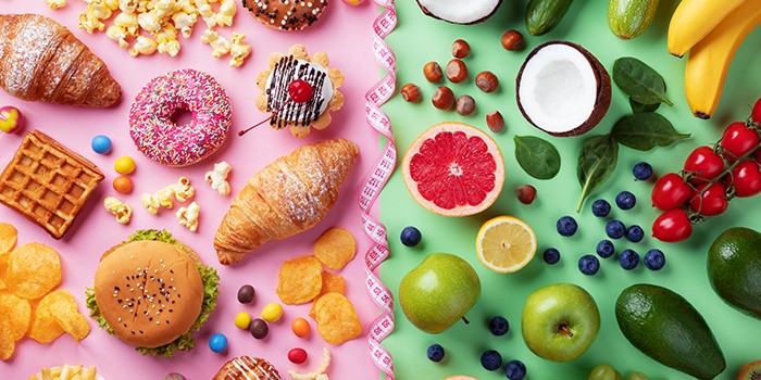 Selection of sugary, unhealthy foods and fresh fruits