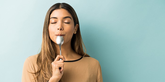 Happy woman with spoon
