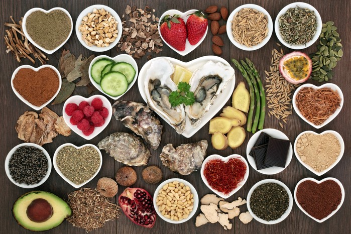 Array of aphrodisiac foods, many in heart-shaped dishes