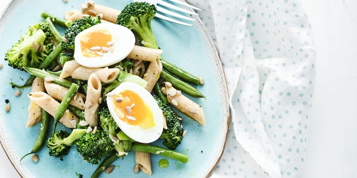 Pasta and broccoli salad with soft-boiled eggs on top