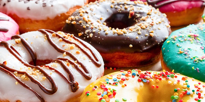 Close-up of brightly decorated iced doughnuts