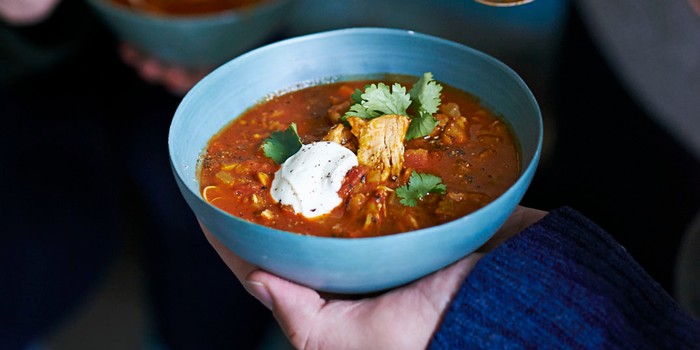 Blue bowl filled with harira and chicken soup