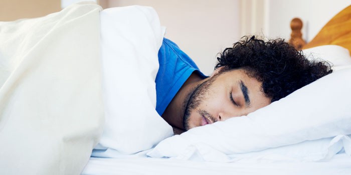 A man sleeping in a bed