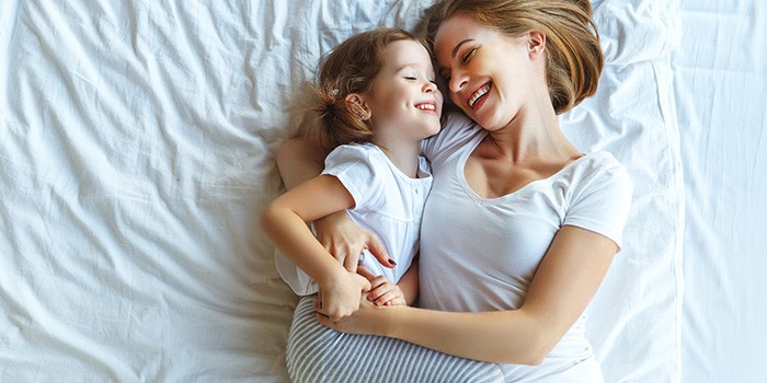 Child hugging on bed