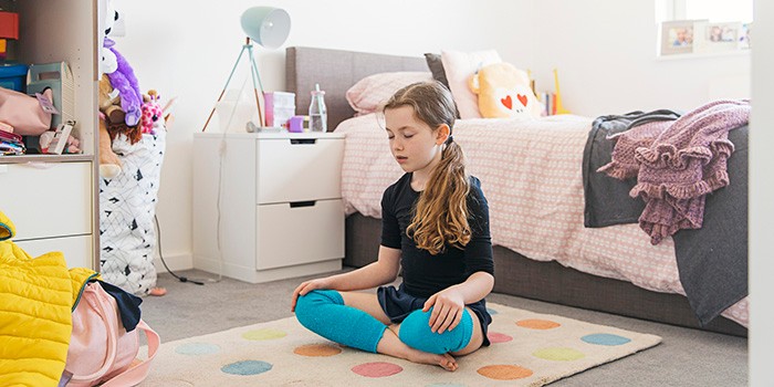 Child meditating in bedroom