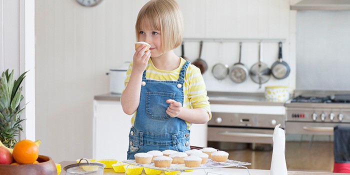 Child smelling cupcake