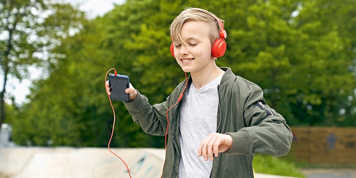 Boy listening to music outside