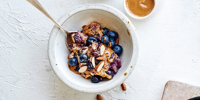 Blueberry baked oats in a bowl with nut butter