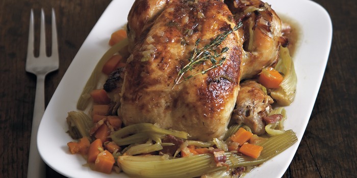 chicken with braised celery and cider on a serving dish