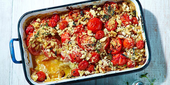 Crunchy baked tomato & onion gratin with a spoonful taken