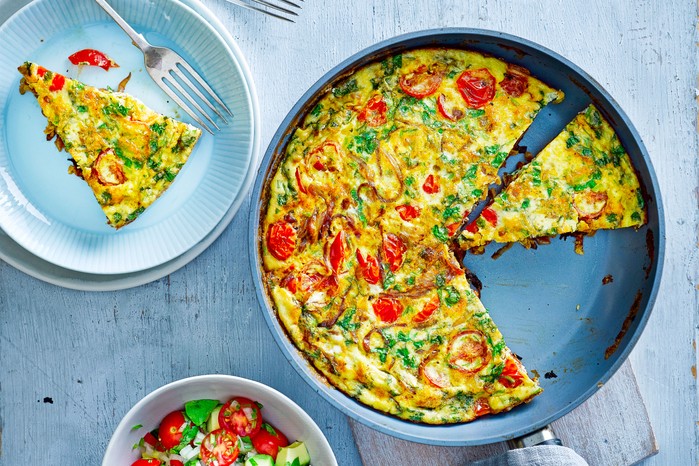 Frittata in a pan and a slice on a plate