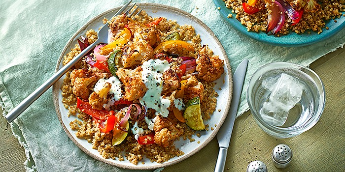 Fennel-roasted cauliflower with quinoa on two white plates