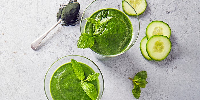 Green spirulina smoothie in two glasses