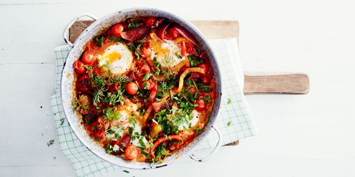 Bowl of shakshuka with eggs and vegetables