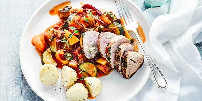 Herb & garlic pork with summer ratatouille and a fork
