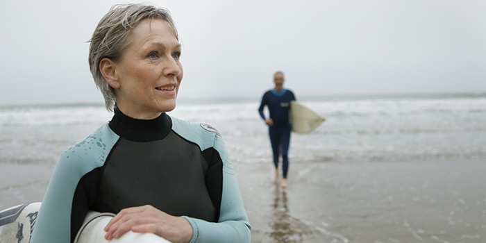 Couple surfing on a beach