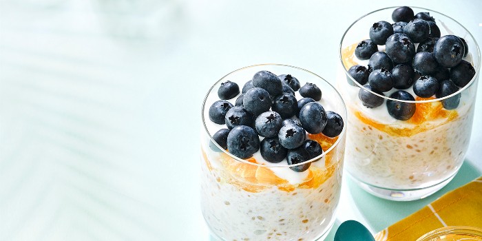 Orange & blueberry Bircher in two glasses