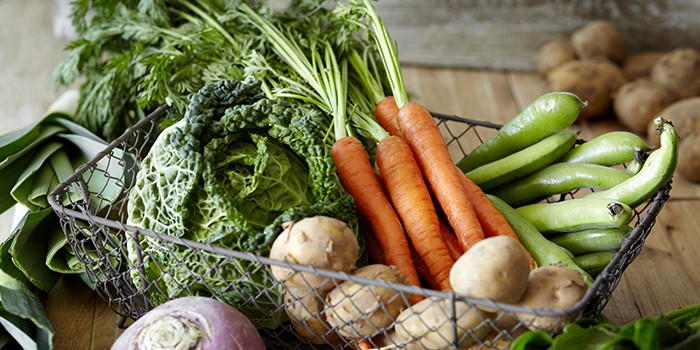 Selection of fresh vegetables in wire basket