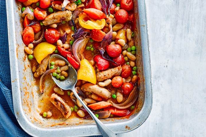 Tray of sausages with tomatoes and other veg