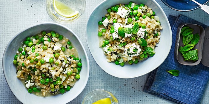 Pea, feta and pearl barley stew in two blue bowls