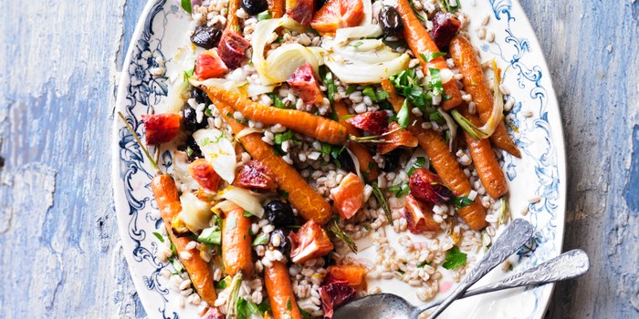 Roasted carrot, spelt, fennel & blood orange salad on a serving dish with serving spoon