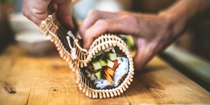 Sushi rolls being made