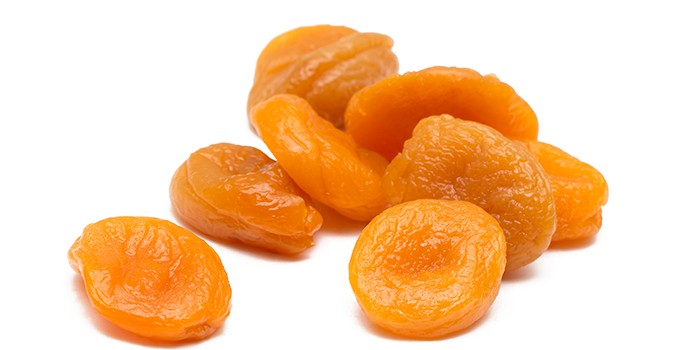 Pile of dried apricots on a white background