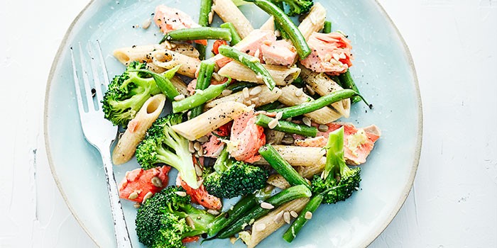 broccoli pasta with salmon on blue plate