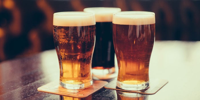 Pints of beer and ale on a wooden table