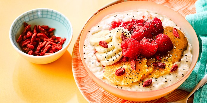Healthy porridge bowl topped with fresh and dried fruit