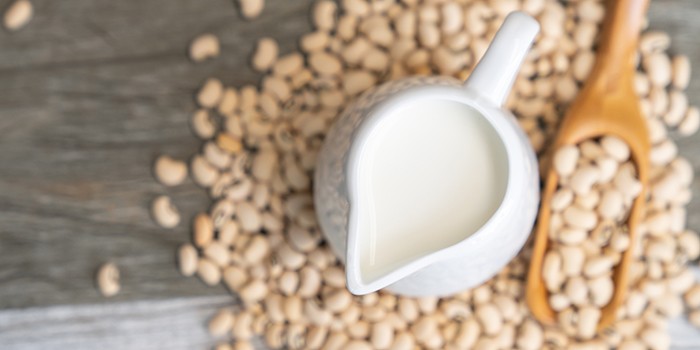 Soy milk and soy bean on wooden background