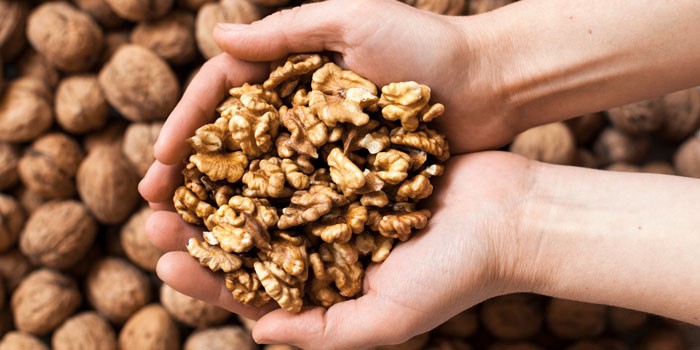 the-health-benefits-of-walnuts-holding-in-hands-700-350-76a36ab