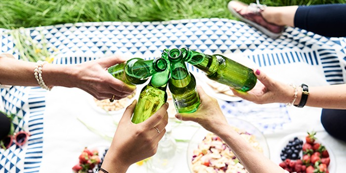 Women clinking low-alcohol beer bottles
