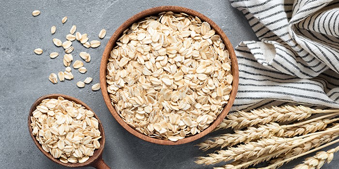 Oats in a wooden bowl with a spoon