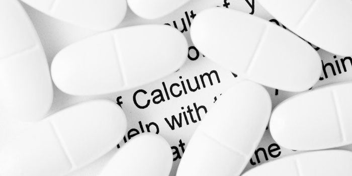 Calcium supplements on a page of text about calcium
