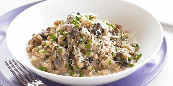 Bowl of spelt & wild mushroom risotto topped with parmesan