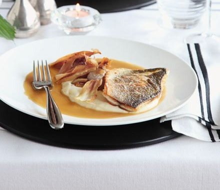 Roast fillet of sea bass with parsnip purée & caramelised garlic recipe